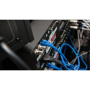 Focusrite ISA ADN8 Dante A/D Card in rackmount, blue Ethernet and black power cables connected, with visible wire tangle.
