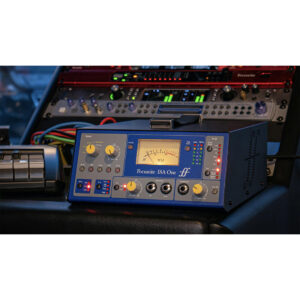 A Focusrite ISA One desktop mic preamp with glowing VU meter, blue chassis, knobs, and colorful cables on a studio desk.
