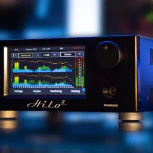 Black Lynx Hilo 2 AD/DA converter with touchscreen, colorful meters, and labeled controls on a reflective surface.