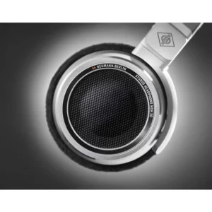 Close-up of a Neumann NDH 30 open-back studio headphone earcup, showcasing the intricate metallic texture, refined Neumann branding, and premium build—immaculately captured against a softly lit, dark background. Discover the precision and quality of Neumann headphones, available now at Providence Sound And Vision.