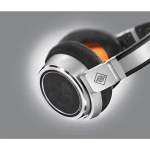 Close-up of the Neumann NDH 30 Open Box headphones, featuring a sleek silver and black over-ear design with a prominent mesh grille, plush padded earcup, and the Neumann logo displayed on the side—available now at Providence Sound And Vision.