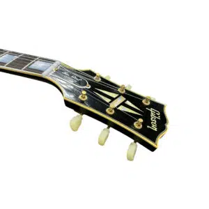 Gibson Custom 1957 Les Paul Reissue headstock close-up, SN 71228, showing logo, inlays, and tuning pegs on white background.