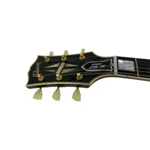 Gibson Custom 1957 Les Paul Reissue black headstock with gold tuners, ivory keys, pearl inlays, and first fret visible.