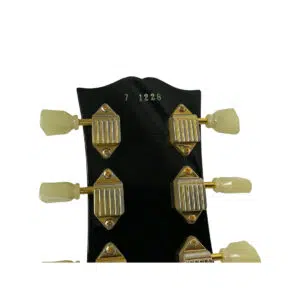 Gibson Custom 1957 Les Paul Reissue SN 71228 headstock, gold tuners with cream knobs, engraved serial, white background.