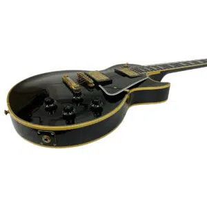 Preowned Gibson Custom 1957 Les Paul Reissue electric guitar, glossy black, gold hardware, cream binding, four black knobs.