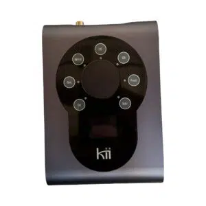 Preowned Kii THREE dark grey pair, compact black/grey remote with circular control panel and small display above logo.
