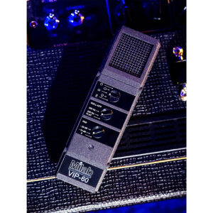 Milab VIP-60 condenser microphone with logo and controls, set on a textured black amp under vibrant blue-purple lighting.