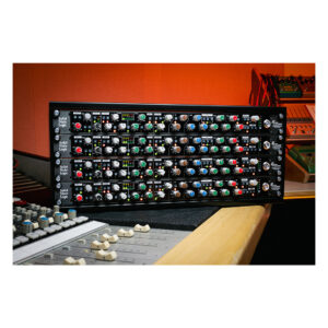 SSL Revival 4000 analog channel strip, rack-mounted with colorful controls, on a studio desk against vibrant orange walls.