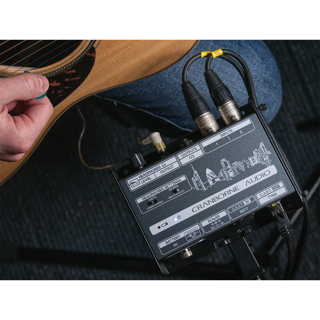 Musician with acoustic guitar beside Cranborne C.A.S.T. Intro Bundle; shows C.A.S.T connectivity, cables, and audio controls.