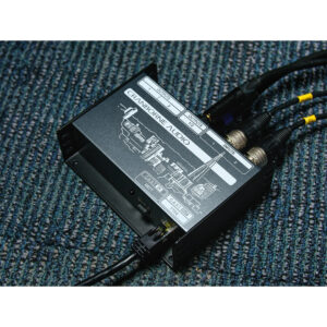 Cranborne C.A.S.T. Intro Bundle, black desktop audio device on blue carpet, cables in INPUT 1, INPUT 2, OUTPUT; city skyline graphic.