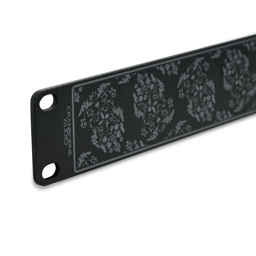 Cranborne Audio Half-Rack Kit black metal panel with floral design, two screw holes, and logo in the corner.