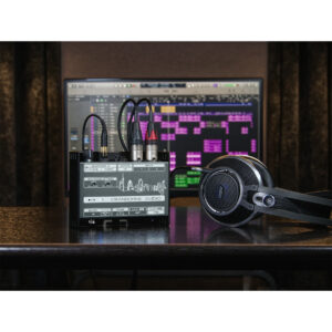 Cranborne N22H audio interface, cables, and closed-back headphones on desk in front of DAW monitor; home studio setup.