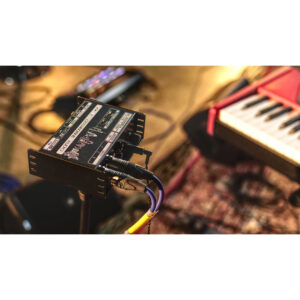 Cranborne N22H audio interface with multiple cables beside a red and white keyboard on a patterned studio rug.