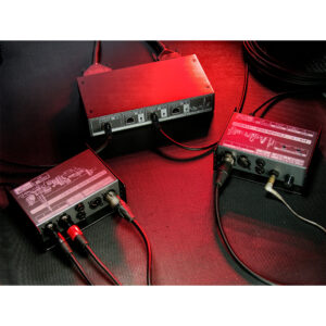 Cranborne N8 rack units linked by cables on a dark surface, under red lighting, showing labeled ports and switches.