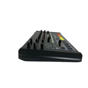 Behringer RD-8 drum machine, preowned, low side view, shows knobs, buttons & colored pads on white background.