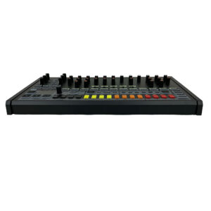 Preowned Behringer RD-8 black drum machine with colorful buttons, multiple knobs; front low-angle view.