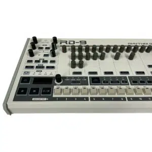 Behringer RD-9 drum machine, preowned, white/gray design with knobs, buttons, sliders for sound and rhythm control.