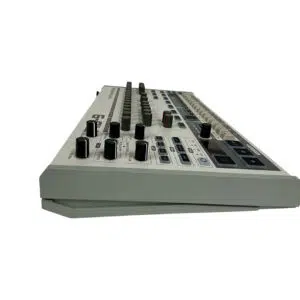 Preowned Behringer RD-9 white drum machine, SN S220601702DG6, with knobs and sliders shown from a low angle on white.