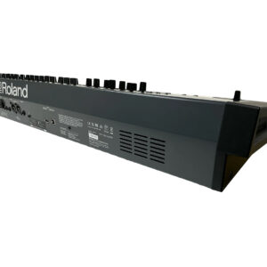 Roland Juno X SN Z5N1615 synthesizer, rear angle showing ports, control knobs, vents; partial Roland logo left.