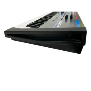 Roland Juno X SN Z5N1615 synth, preowned, side view, black casing, white/black keys, top knobs/buttons, left end focus.