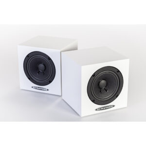 Auratone 5C Active white speakers, cube-shaped with black front grilles, placed side by side on a white surface.
