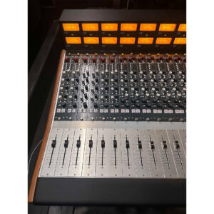 Rupert Neve Designs 5088 Console SN 0251, preowned, close-up of sliders, knobs, VU meters in dim studio lighting.