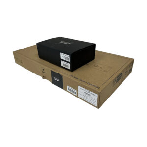 Black box atop larger brown cardboard box labeled "The New Studio Essential," on white background. Brand labels visible.