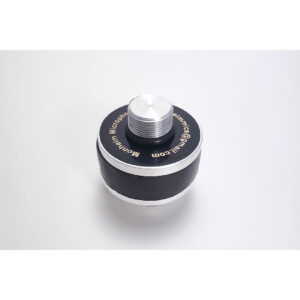 Monheim Decoupler, round black and silver metal device with threaded top, “microminim.com” engraved on black ring.