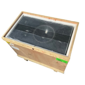 ATC SCM150Ai black speaker, preowned, partially wrapped in plastic inside an open wooden shipping crate.